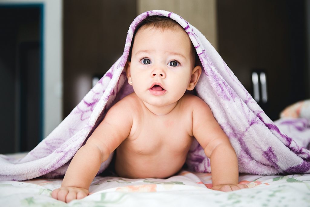Baby peaking out from under blanket - Circle of Security Parenting